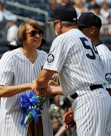 Arlene Howard, the widow of former New York Yankees' catcher Elston Howard, receives flowers from Gossage